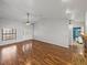 Open-concept living area featuring wood-look floors, and views to the entry doors and a full bathroom at 18253 Townsend House Rd, Dade City, FL 33523
