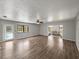 Spacious living room featuring wood floors and a door to the pool area at 18253 Townsend House Rd, Dade City, FL 33523