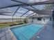 Backyard pool with screened enclosure and lake view at 18253 Townsend House Rd, Dade City, FL 33523