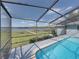 Backyard pool with screened enclosure and lake view at 18253 Townsend House Rd, Dade City, FL 33523