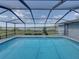 Screened-in pool area with beautiful lake views, perfect for outdoor enjoyment at 18253 Townsend House Rd, Dade City, FL 33523