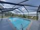 Backyard pool with screened enclosure and lake view at 18253 Townsend House Rd, Dade City, FL 33523