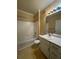 Well-lit bathroom featuring a vanity, a bathtub with shower, and neutral tile at 18575 Bridle Club Dr # 18575, Tampa, FL 33647