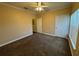 Cozy bedroom featuring a ceiling fan, neutral walls and carpet, and plenty of natural light at 18575 Bridle Club Dr # 18575, Tampa, FL 33647