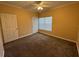 Bedroom with a large window, plush carpet, and ample natural light, creating a cozy atmosphere at 18575 Bridle Club Dr # 18575, Tampa, FL 33647