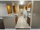 Kitchen with tile flooring, white appliances, wood cabinets, and breakfast bar seating at 18575 Bridle Club Dr # 18575, Tampa, FL 33647