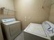 Functional laundry room with washer, dryer, and shelving for organized storage at 18575 Bridle Club Dr # 18575, Tampa, FL 33647