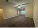 Neutral living room with large window for natural light and ceiling fan at 18575 Bridle Club Dr # 18575, Tampa, FL 33647