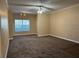 Living room with plush carpet, large window with blinds, and ceiling fan at 18575 Bridle Club Dr # 18575, Tampa, FL 33647