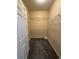 Spacious walk-in closet with shelving and carpeted floor, perfect for organization and storage at 18575 Bridle Club Dr # 18575, Tampa, FL 33647