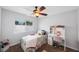 Bright bedroom featuring a large window, desk, and ceiling fan, creating a comfortable and functional space at 1947 Citrus Hill Ln, Palm Harbor, FL 34683
