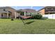 Green backyard featuring lush grass, shade trees and a hammock for relaxing in outdoor bliss at 20220 Autumn Fern Ave, Tampa, FL 33647