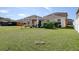 Expansive backyard with lush green lawn, patio and hammock for outdoor relaxation at 20220 Autumn Fern Ave, Tampa, FL 33647