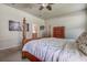 Cozy bedroom showcasing a wooden four poster bed with white linens and an adjacent en-suite bathroom at 20220 Autumn Fern Ave, Tampa, FL 33647