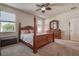 Spacious bedroom featuring a four poster bed, carpet and plenty of natural light from two windows at 20220 Autumn Fern Ave, Tampa, FL 33647
