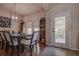 Dining room with hardwood floors, decorative lighting, and a door with leaded glass at 20220 Autumn Fern Ave, Tampa, FL 33647