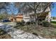 Charming two-story home with a well-maintained lawn, beautiful landscaping, and a spacious driveway, nestled under mature trees at 20220 Autumn Fern Ave, Tampa, FL 33647
