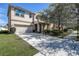 Well-manicured front lawn, a spacious driveway leading to a two-car garage, and mature trees offering shade at 20220 Autumn Fern Ave, Tampa, FL 33647