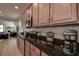 Kitchen featuring stainless steel appliances, dark countertops, and wood cabinets at 20220 Autumn Fern Ave, Tampa, FL 33647