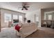Bright living room featuring a ceiling fan, large windows and an open floor plan at 20220 Autumn Fern Ave, Tampa, FL 33647