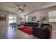 Cozy living room with lots of natural light, tile floors, ceiling fan and modern furniture at 20220 Autumn Fern Ave, Tampa, FL 33647