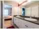 Well-lit double sink bathroom with a view into the main bedroom at 21011 Picasso Ct # 101, Land O Lakes, FL 34637