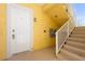 Entrance to unit 101 with secure door, stairway, and wall-mounted lighting at 21011 Picasso Ct # 101, Land O Lakes, FL 34637