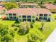 Two-story condo with balconies overlooking lush landscaping, offering serene views and outdoor living at 21011 Picasso Ct # 101, Land O Lakes, FL 34637