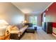 Comfortable living room with a plush sofa, ceiling fan, and natural light from the sliding glass door at 21011 Picasso Ct # 101, Land O Lakes, FL 34637