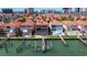 Aerial view of waterfront property with a screened-in pool, boat dock, and access to the channel at 218 Sand Key Estates Dr, Clearwater Beach, FL 33767