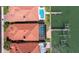 Aerial view of a waterfront home with a private pool and dock access, featuring a red tile roof at 218 Sand Key Estates Dr, Clearwater Beach, FL 33767