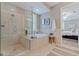 Well-lit bathroom with a luxurious tub, a separate glass shower, and soothing decor at 218 Sand Key Estates Dr, Clearwater Beach, FL 33767