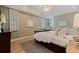 Cozy bedroom with natural light, hardwood floors, neutral paint, and comfortable furnishings at 218 Sand Key Estates Dr, Clearwater Beach, FL 33767