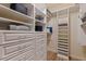 Organized walk-in closet with custom shelving and drawers for maximum storage and convenience at 218 Sand Key Estates Dr, Clearwater Beach, FL 33767