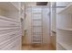 Walk-in closet with custom shelving units and drawers, offering ample storage space and organization at 218 Sand Key Estates Dr, Clearwater Beach, FL 33767