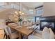 The dining area has fireplace views, an elegant chandelier, and a seamless flow to the living room at 218 Sand Key Estates Dr, Clearwater Beach, FL 33767