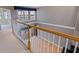 Well-lit hallway featuring a wood and white banister, bright sunlight and water views at 218 Sand Key Estates Dr, Clearwater Beach, FL 33767