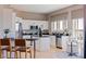 Modern kitchen with white cabinets, stainless steel appliances, and an island for dining at 218 Sand Key Estates Dr, Clearwater Beach, FL 33767