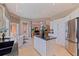 Open kitchen with stainless appliances, island with dark granite countertop, and adjoining dining area at 218 Sand Key Estates Dr, Clearwater Beach, FL 33767