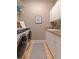 Well-equipped laundry room with granite countertops, wooden cabinets, sink, and washer/dryer at 218 Sand Key Estates Dr, Clearwater Beach, FL 33767