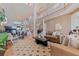 Open living room featuring a fireplace, staircase, and a seamless connection to the dining area at 218 Sand Key Estates Dr, Clearwater Beach, FL 33767