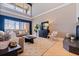 Elegant living room featuring large windows with a view, stylish furnishings, and wood floors at 218 Sand Key Estates Dr, Clearwater Beach, FL 33767