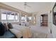Bright main bedroom featuring water views, a ceiling fan and a private doorway to the staircase at 218 Sand Key Estates Dr, Clearwater Beach, FL 33767