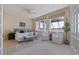 Main bedroom with views of the ocean, a ceiling fan, and a seating area near the window at 218 Sand Key Estates Dr, Clearwater Beach, FL 33767
