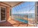 Covered patio boasts stunning waterfront views, a private pool, and seamless indoor-outdoor living at 218 Sand Key Estates Dr, Clearwater Beach, FL 33767