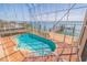 Enclosed waterfront pool features clear blue water, a patio, and dock access with a boat lift at 218 Sand Key Estates Dr, Clearwater Beach, FL 33767