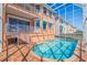 Screened in pool area with brick deck and access to the main house from several floors at 218 Sand Key Estates Dr, Clearwater Beach, FL 33767