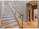 Elegant stairway with wood steps, white risers, and natural light, connecting the floors beautifully at 218 Sand Key Estates Dr, Clearwater Beach, FL 33767