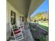 Cozy front porch with rocking chairs, decorative plants, and well-maintained pavers at 2208 Parkwood Dr, Valrico, FL 33594