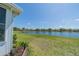 Beautiful backyard view overlooking a serene lake and lush green lawn on a sunny day at 2234 Nottingham Greens Dr # 2234, Sun City Center, FL 33573